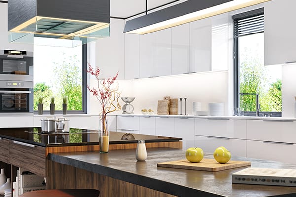 Bright modern Port Moody kitchen with proper lighting and placement above counters and work areas