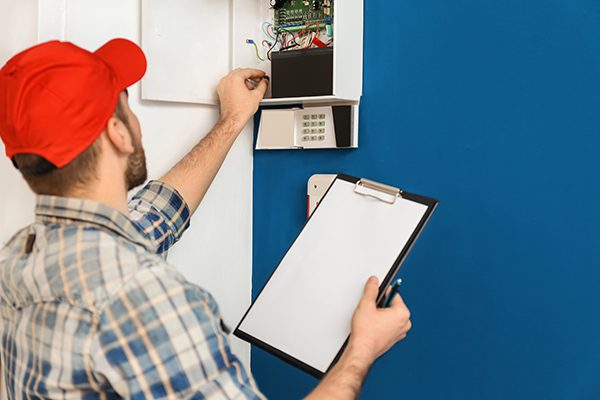 Licensed electrician inspects an electrical panel in a Coquitlam house